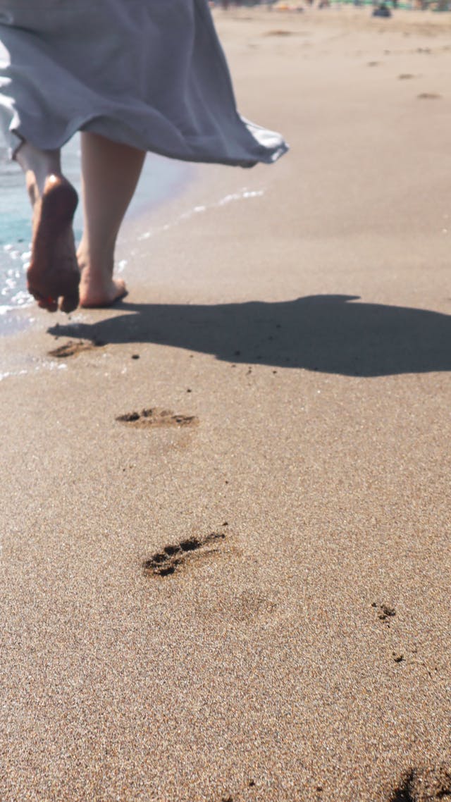 vrouw loopt op het strand